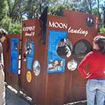 Woman looking at interpretive signage about the moon landing